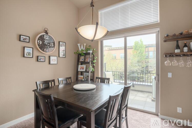 A dining room with a wooden table and chairs.