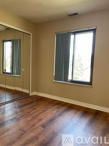 A room with a sliding glass door and a window.