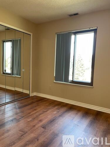 A room with a sliding glass door and a window.
