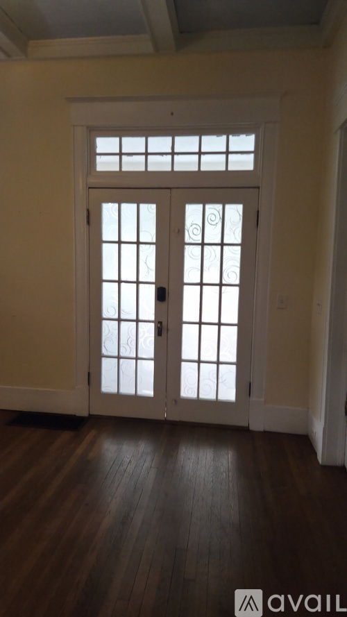 A white door with a glass panel and a handle.