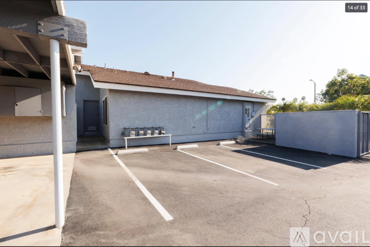A parking lot with a building in the background and a sign that says "available".