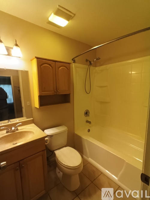 A bathroom with a toilet, sink, and bathtub.