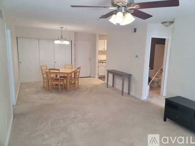 A living room with a dining table and chairs.