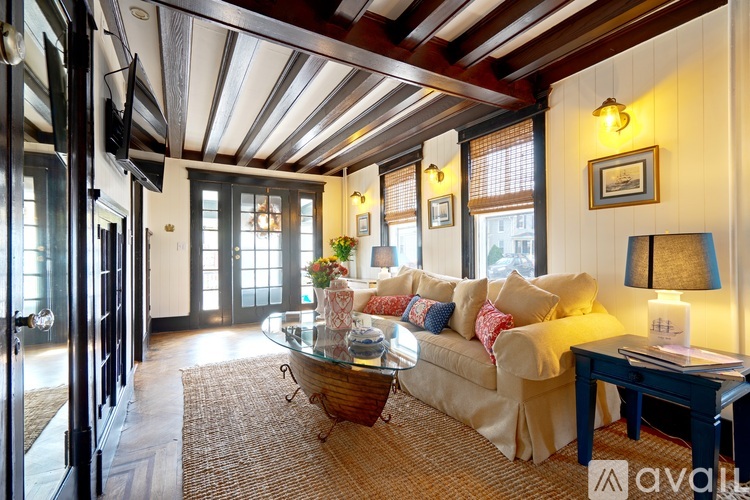 A living room with a couch, coffee table, and a lamp.