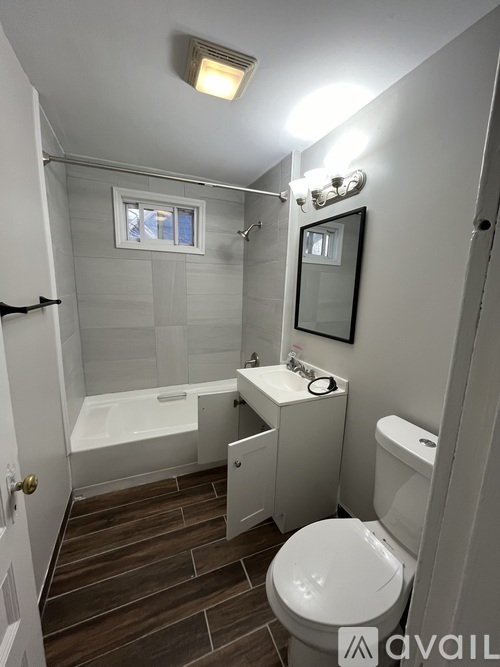 A small bathroom with a toilet, sink, and bathtub.