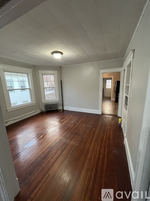 A room with wooden floors and white walls.