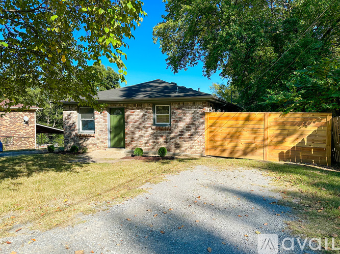 A house with a driveway and a wooden fence.
