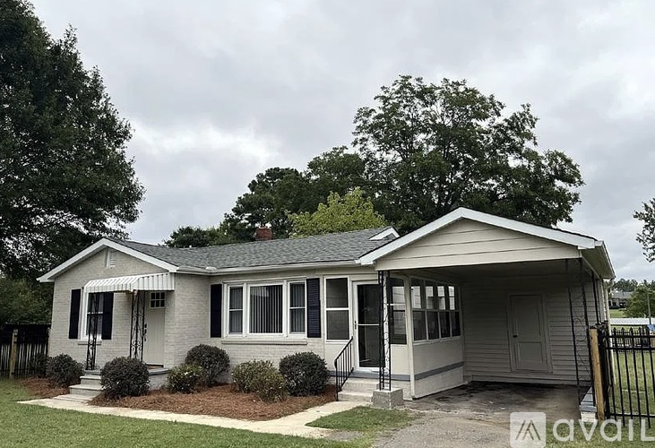 A house with a grey roof and a white porch.