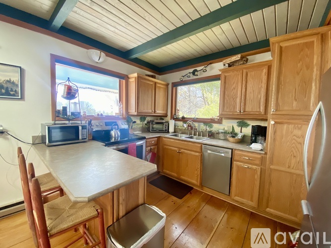 A kitchen with wooden cabinets and a white refrigerator.