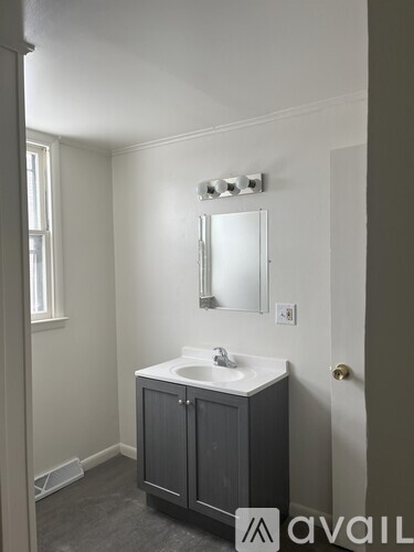 A bathroom with a sink and a mirror above it.
