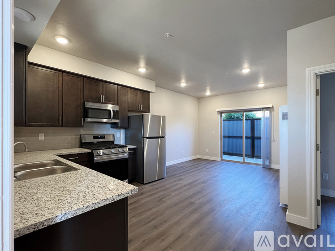 A kitchen with dark wood cabinets and stainless steel appliances.