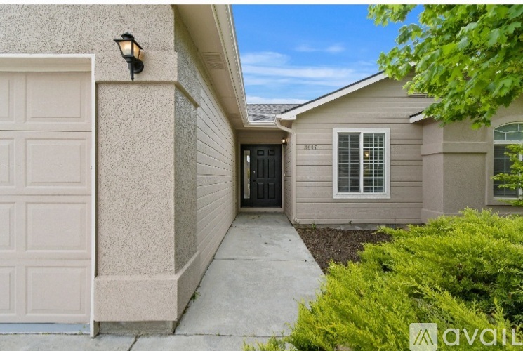 A house with a beige garage door is for sale.