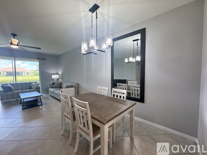 A dining room with a wooden table and chairs.