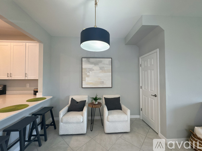 A living room with two chairs and a table.