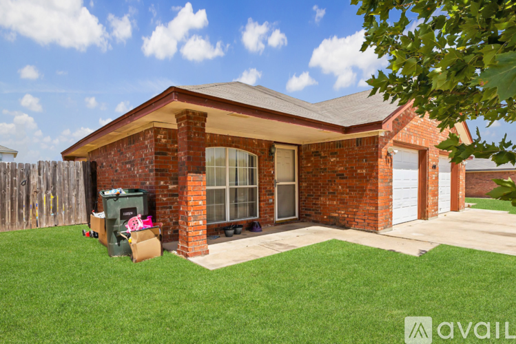 A house with a red brick exterior and a white garage door.