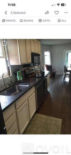 A kitchen with wooden cabinets and black countertops.