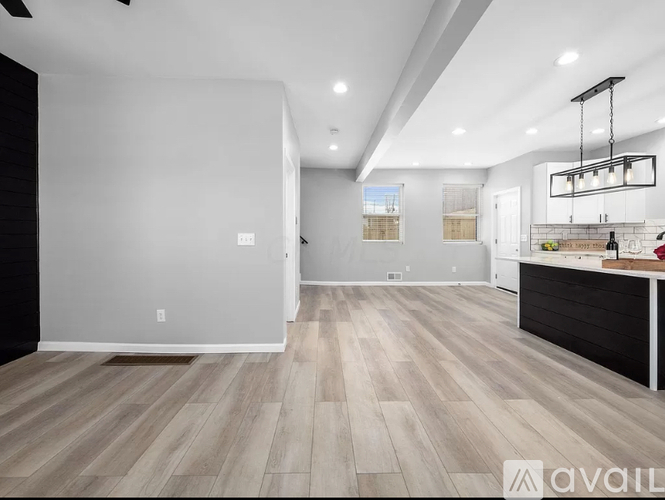 A modern kitchen with a bar area and a dining area.