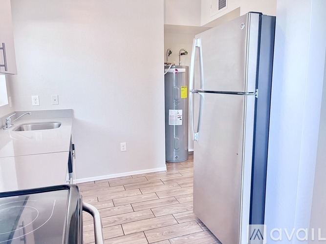 A kitchen with a stainless steel refrigerator and a stainless steel dishwasher.