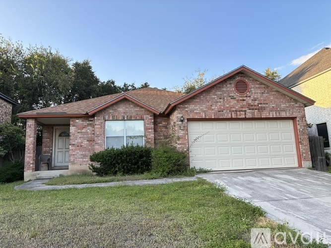 A red brick house with a white garage door.
