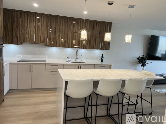 A modern kitchen with a white table and chairs.