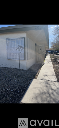 A house numbered 203 with a butterfly decoration on the window.