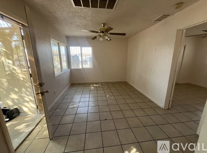 A room with a ceiling fan and tile flooring is available for rent.