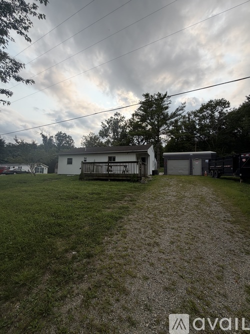 A house with a yard and a sign that says "available" in the foreground.