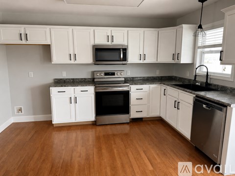 A kitchen with white cabinets and stainless steel appliances.