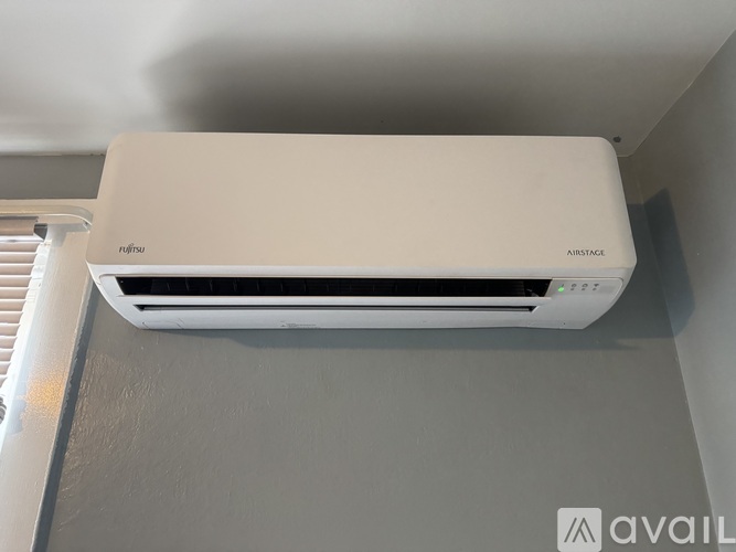 A white air conditioner unit is mounted on a wall.