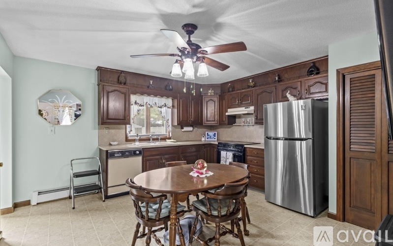A kitchen with a table and chairs in the middle of the room.