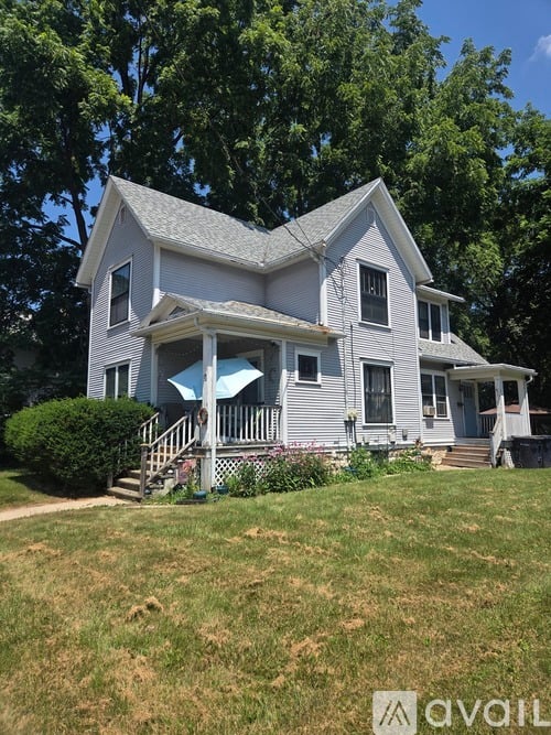 A two-story house with a porch and a covered staircase.