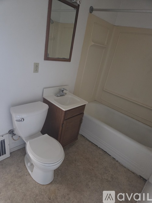 A white toilet sits next to a sink in a bathroom.