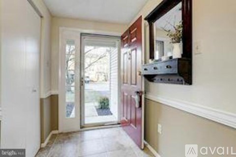 A kitchen area with a stove top oven and a window.