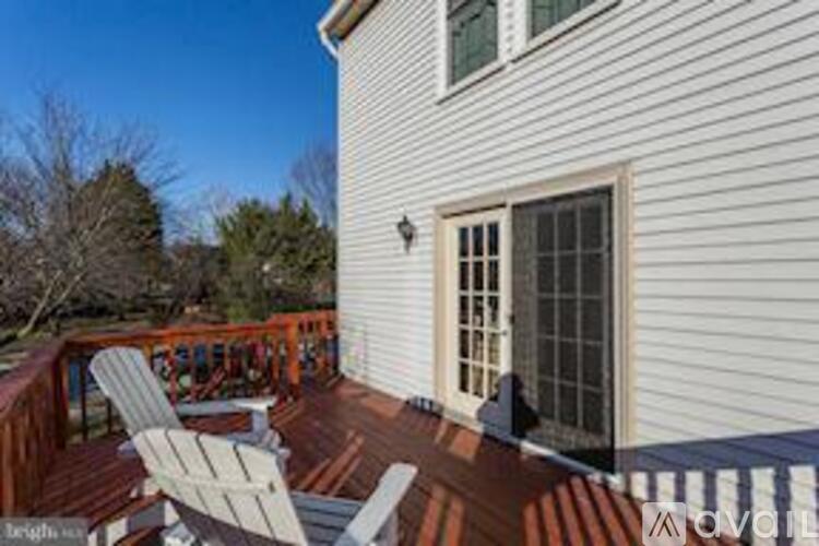 A house with a deck and a chair.