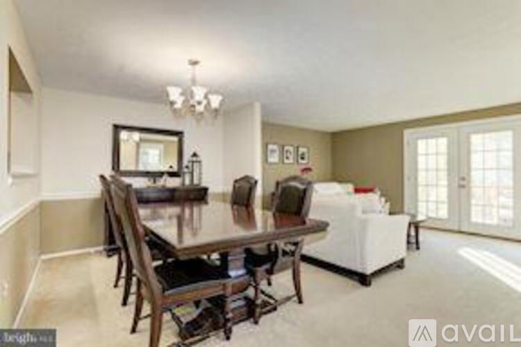 A dining room with a table and chairs.