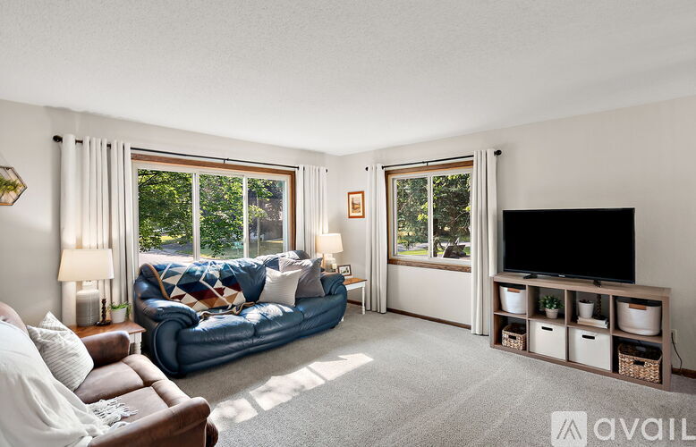 A living room with a blue sofa and a television.