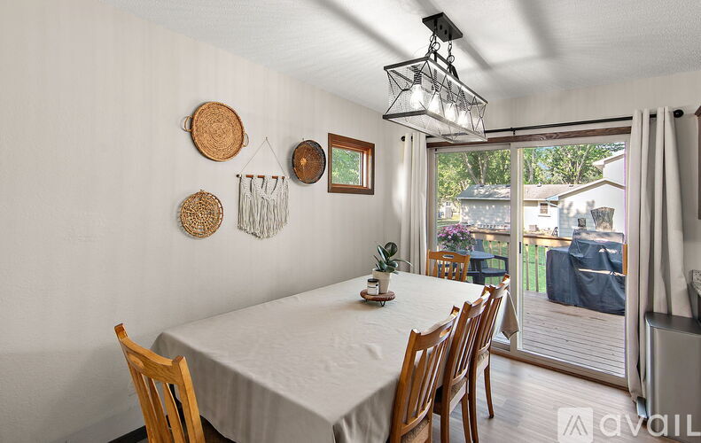 A dining room with a table and chairs.