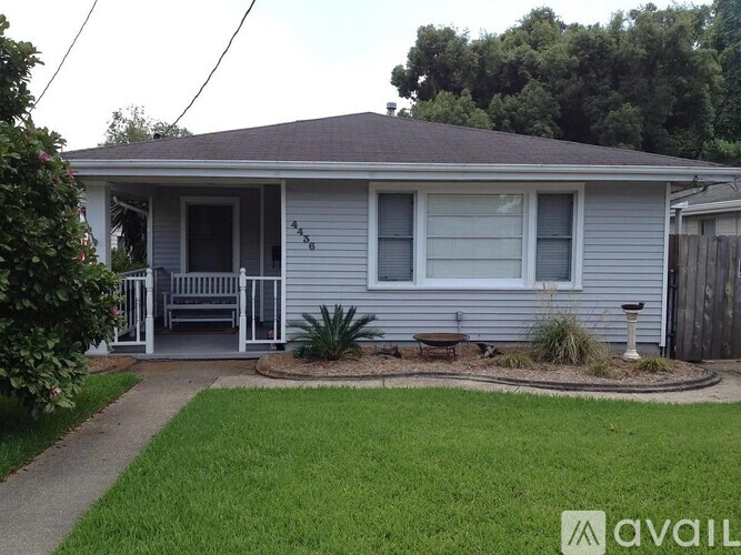 A house with a grey roof and a white door is for sale.