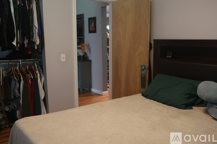 A bedroom with a bed, a wardrobe and a nightstand.