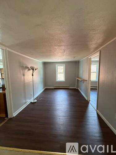 A room with wooden floors and white walls.
