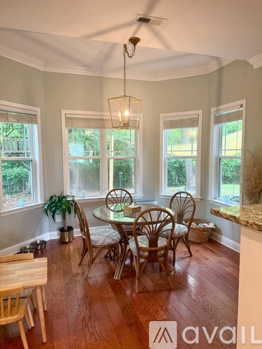 A dining room with a round table and chairs.