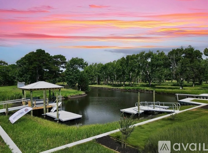 A serene lakeside scene with a gazebo and dock.