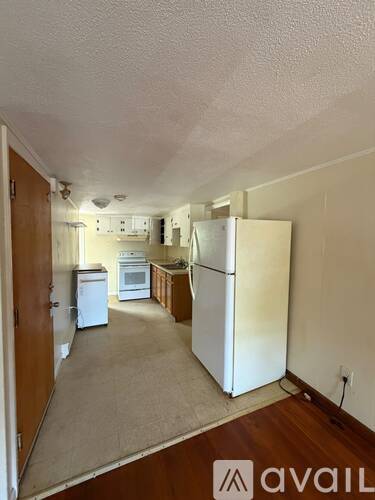 A kitchen with white appliances and a white refrigerator.