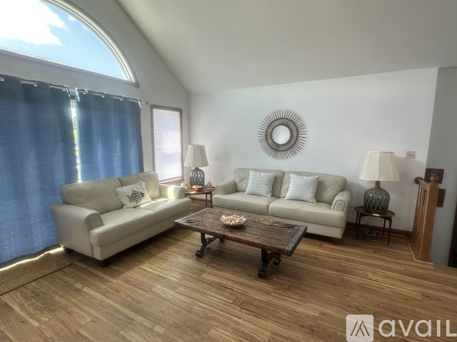 A living room with a couch, a chair, and a coffee table.