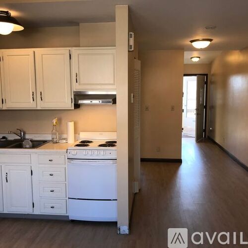 A kitchen with white appliances and cabinets.