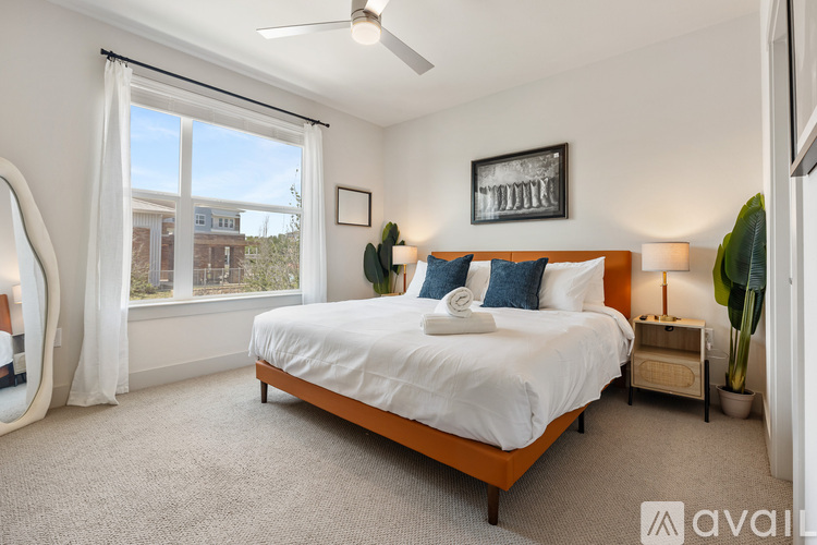 A bedroom with a large bed and a ceiling fan.