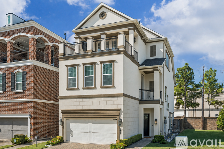 A two-story house with a balcony and a garage.