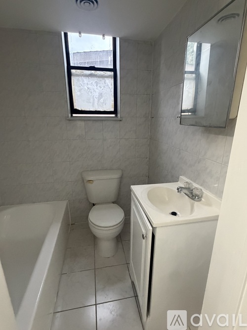 A white toilet and sink in a small bathroom.