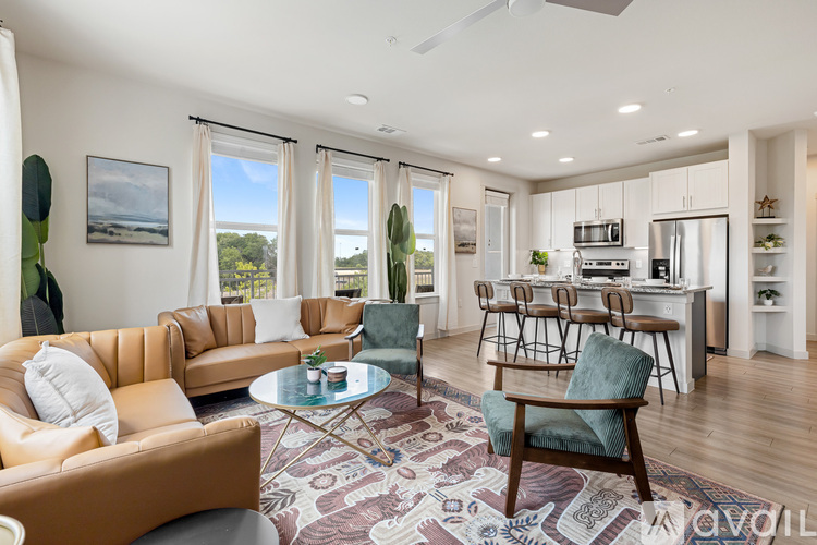 A living room with a brown leather couch, a glass coffee table, and a dining table with chairs.