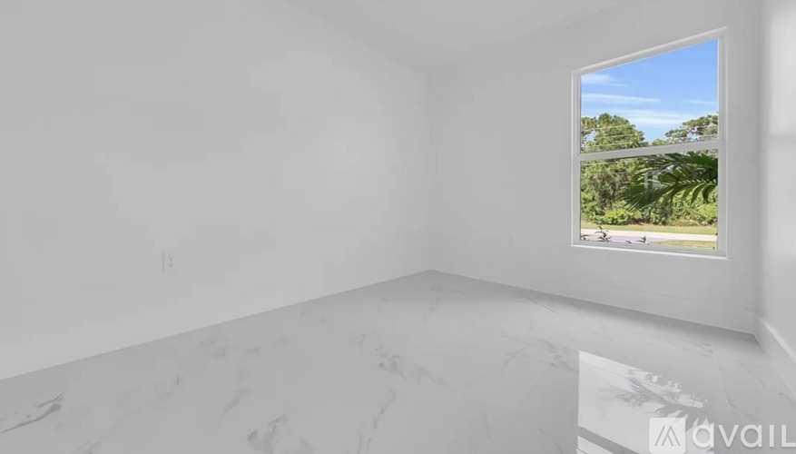 A room with a marble floor and a window showing a view of trees and a road.